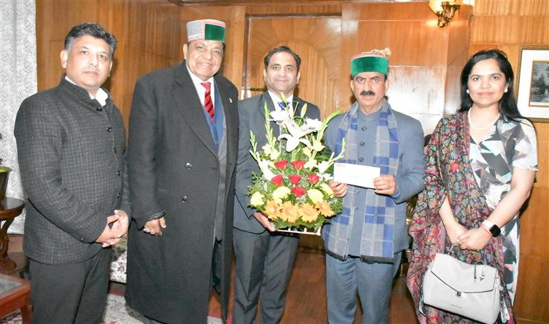 Himachali Pravasi Global Association Canada presented a cheque of ₹3,60,000 to Chief Minister